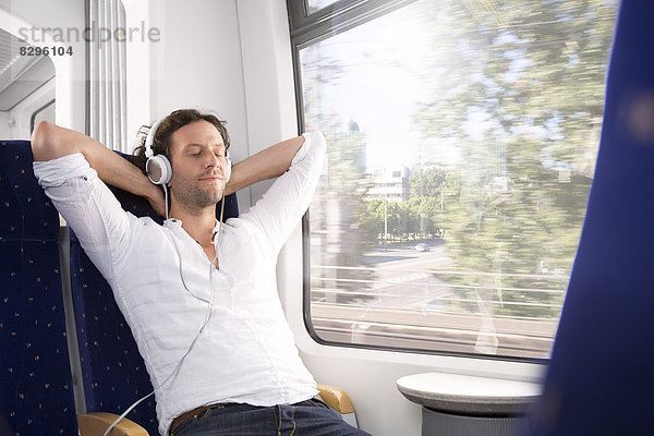 Man with headphones in a train