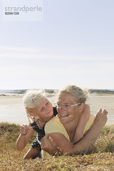 France  Bretagne  Landeda  Mother and daughter lying at the coast