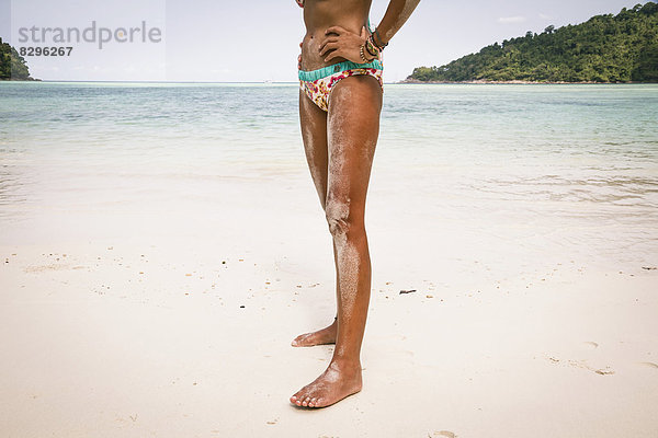 Thailand  Koh Surin island  woman standing at white sandy beach