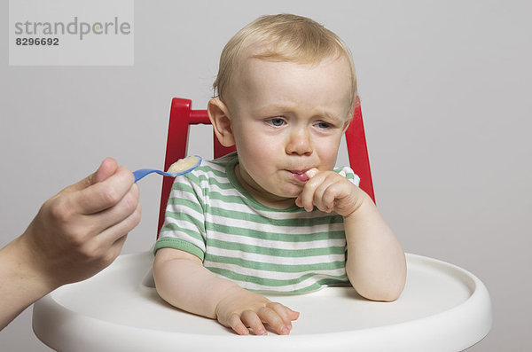 Baby boy refusing food  studio shot