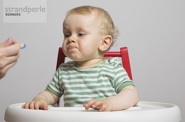 Baby boy refusing food  studio shot