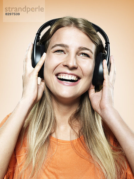 Portrait of young woman with headphones  studio shot