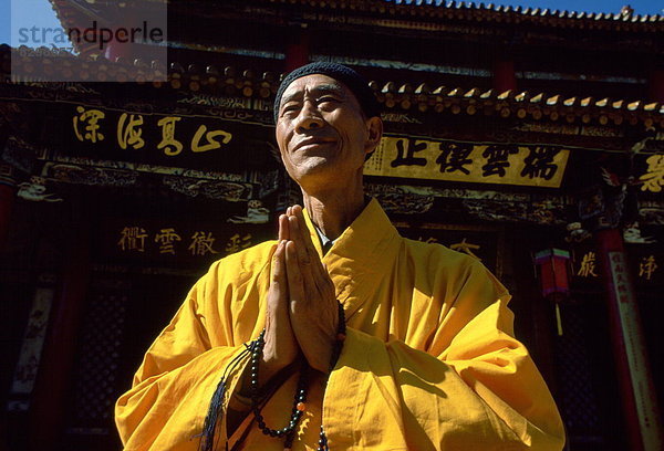 Farbaufnahme  Farbe  Zusammenhalt  Nachthemd  Gebet  fünfstöckig  Buddhismus  Safran  China  Mönch
