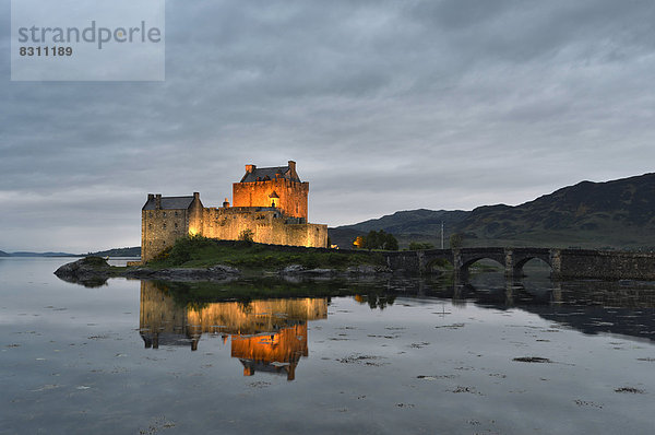 Eilean Donan Castle  Stammsitz des schottischen Clans der Macrae  spiegelt sich am Abend im Loch Duich