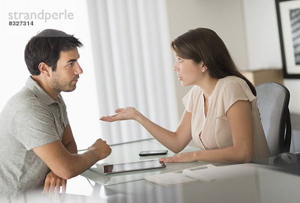 Man and woman talking in office