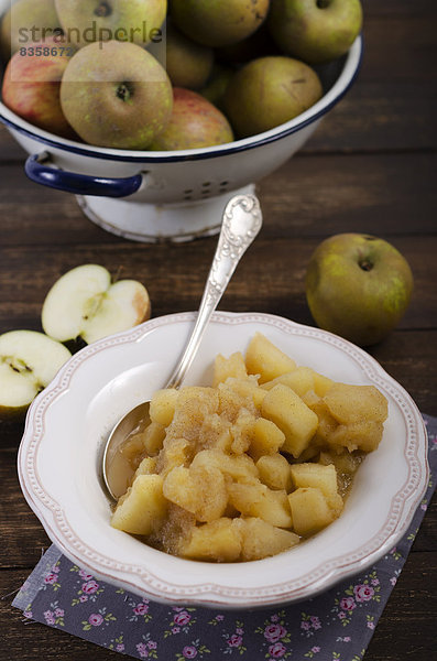 Homemade apple compote on wooden table