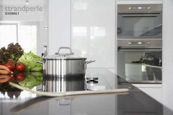 Germany    Pot and vegetables on kitchen surface
