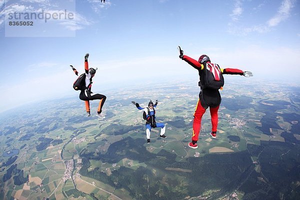Drei Fallschirmspringer frei über Leutkirch  Bayern  Deutschland