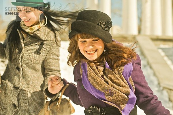 Zwei junge Frauen beim Laufen im Schnee