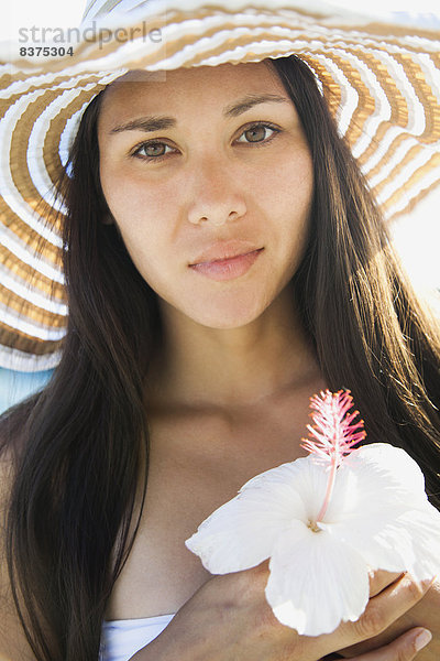 Vereinigte Staaten von Amerika  USA  Sonnenhut  Portrait  Frau  Blume  halten  jung  Hawaii  Hibiskus  Oahu  Waikiki