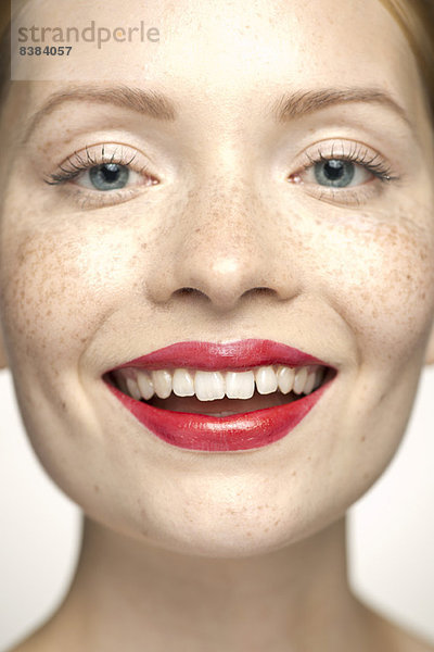 Junge Frau mit rotem Lippenstift  lächelnd  Portrait