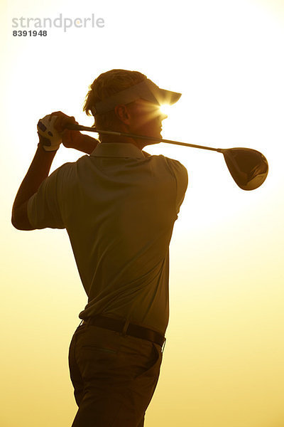 Silhouette des Mannes schwingender Golfschläger