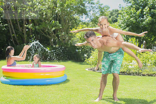 Vater und Tochter spielen im Hinterhof