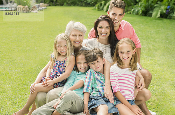 Mehrgenerationen-Familie lächelt zusammen im Hinterhof