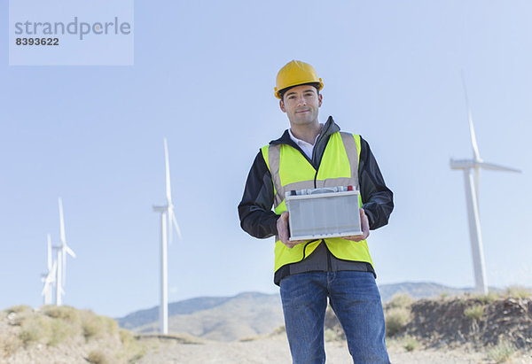 Arbeiter an Windkraftanlagen in ländlicher Landschaft