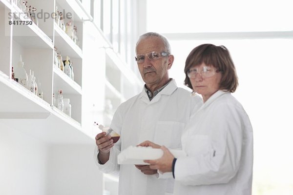 Im Labor arbeitende Wissenschaftler  Probe in Glasflasche