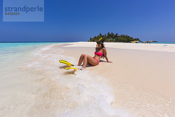 Maledives  young woman sitting at beach