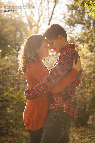 Happy young couple enjoying autumn in a park