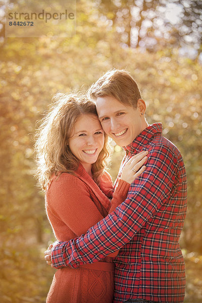 Happy young couple enjoying autumn