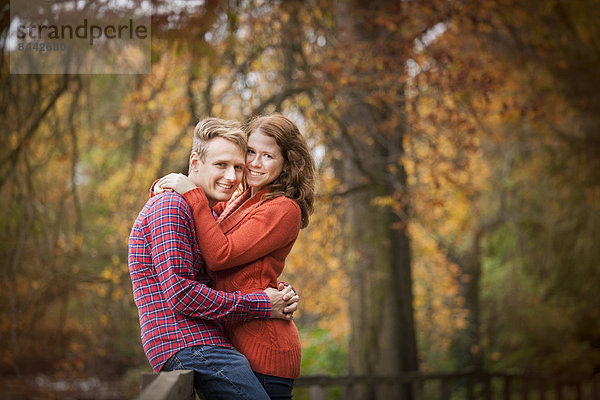 Happy young couple enjoying autumn in a park