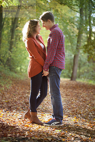 Happy young couple enjoying autumn in a park