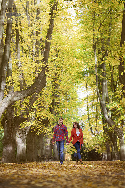 Happy young couple enjoying autumn in a park