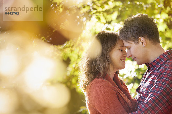 Happy young couple enjoying autumn in a park