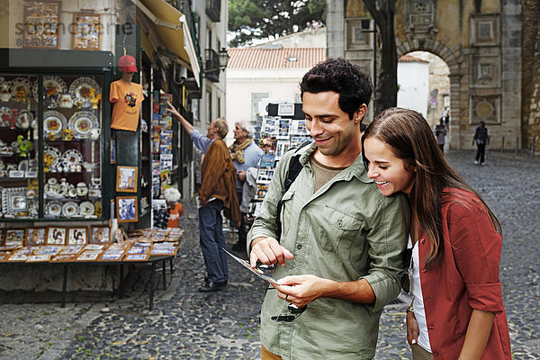Portugal  Lisboa  Baixa  Rossio  young couple looking at postcard