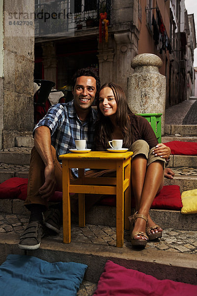 Portugal  Lisboa  Bairro Alto  young couple sitting at street cafe at dusk