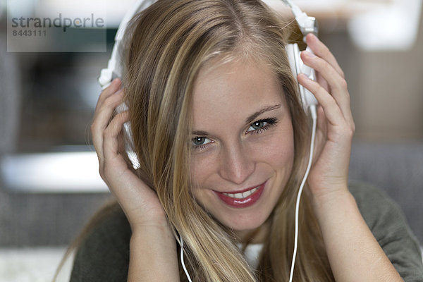 Portrait of smiling young woman with headphones