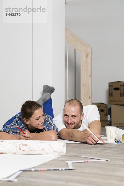 Young couple moving into new home  taking a break