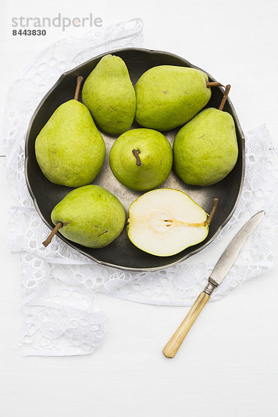 Pears and a knife in a bowl