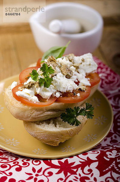Baguette with tomatoes  sheep's cheese and basil