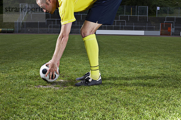 Soccer player placing ball on penalty spot