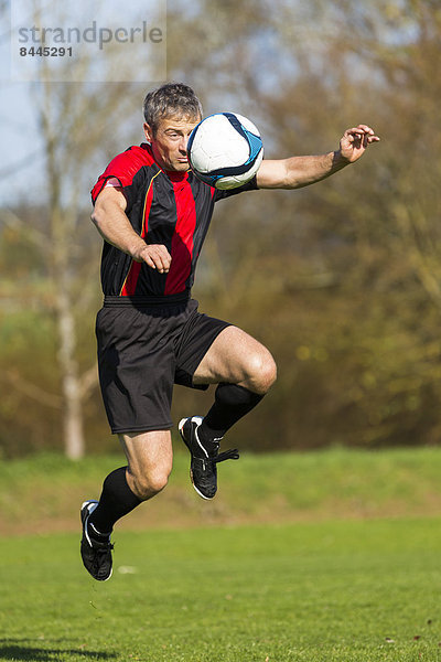 Soccer player with ball on field