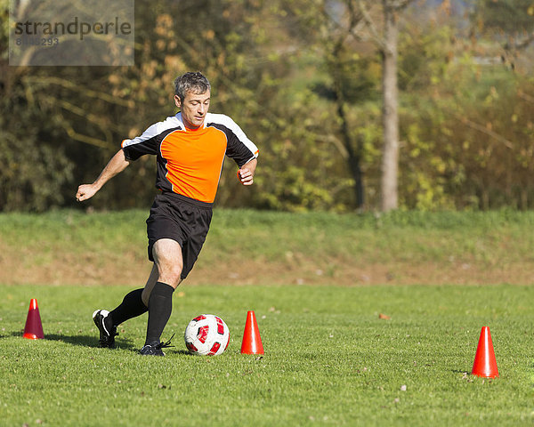 Soccer player passing a slalom course