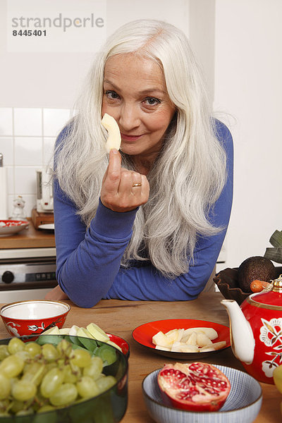 Senior woman eating raw food