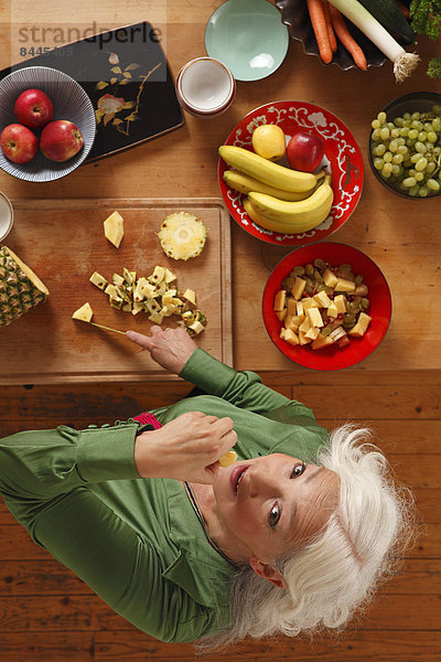 Senior woman preparing raw food