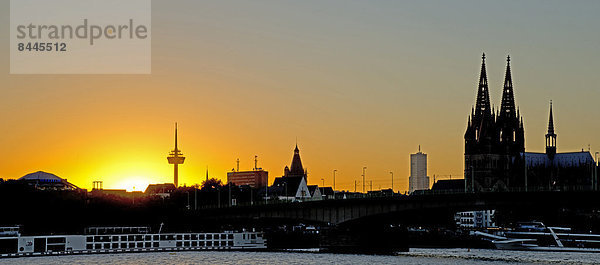 Germany  North Rhine-Westphalia  Cologne  view from Deutz riverside to Cologne Cathedral over Rhine river during sunset
