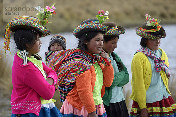 Junge Frauen in bunter  traditioneller Tracht und Baby im Tragetuch  Quispillacta  Ayacucho  Peru
