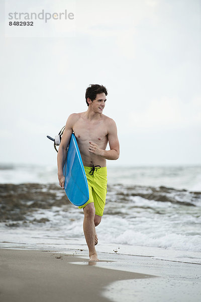 Mann tragen Strand Hispanier Surfboard