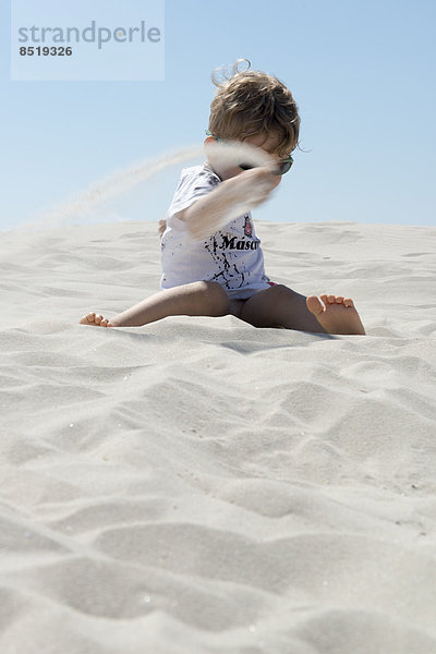 Boy playing with sand