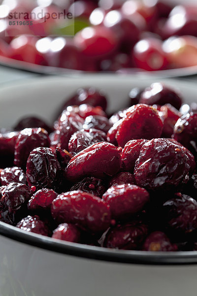 Two bowls of dried and fresh cranberries (ßaccinium macrocarpon)  close-up