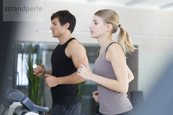 Austria  Klagenfurt  Couple training on treadmill