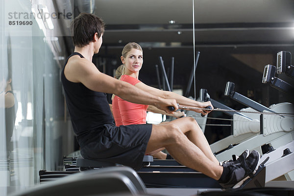 Austria  Klagenfurt  Man and woman exercising with rowing machine
