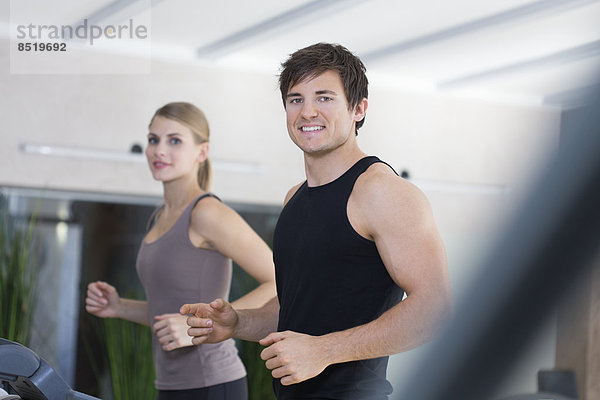 Austria  Klagenfurt  Couple training on treadmill