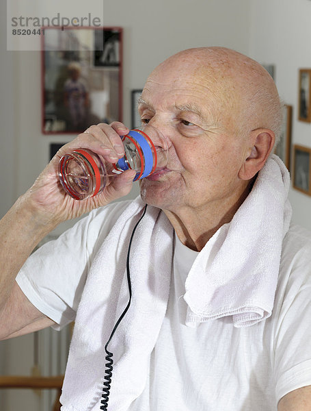 Portrait of old man drinking water