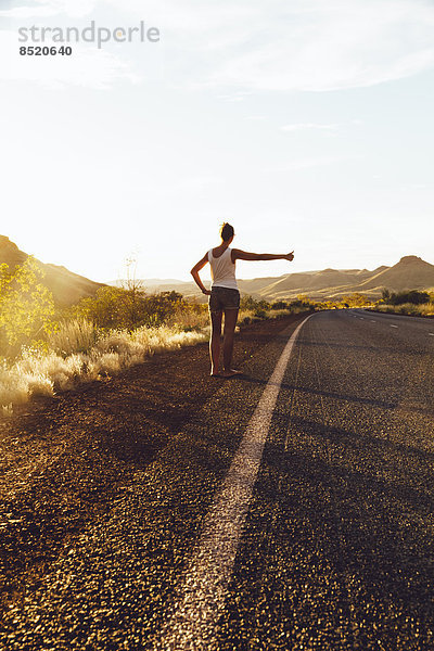 Australia  Young woman hitchhiking