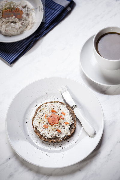 German dark multi-grain bread with cream cheese and carrots  cup of coffee
