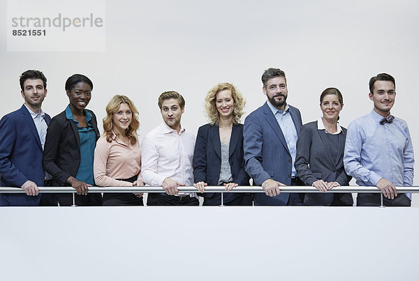 Germany  Neuss  Group of business people standing behind railing